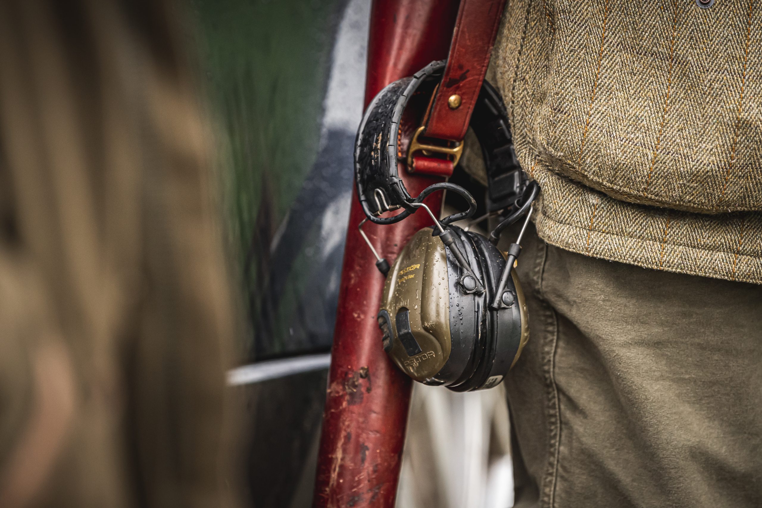 Gun in a gunslip with ear defenders on the strap