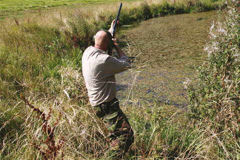 Wildfowler waiting for a clay practice target.