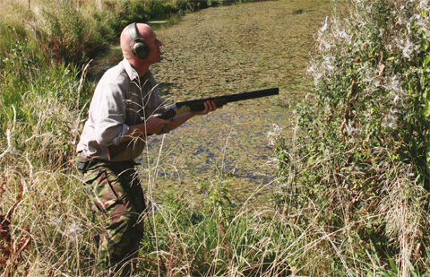 Wildfowler waiting for a clay practice target.